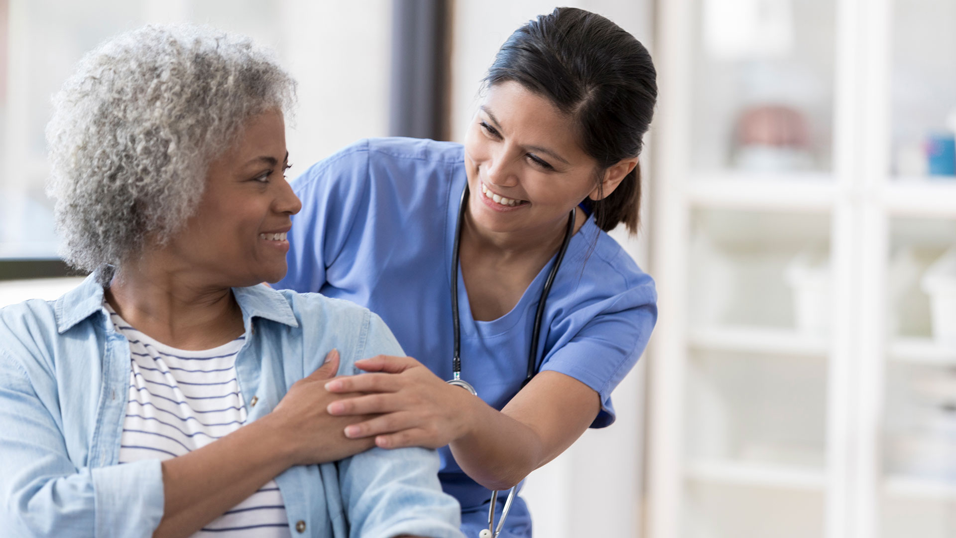 Photo of woman and health care worker interacting
