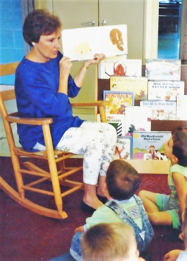 Photo of D. Hoover reading to her first grade students.